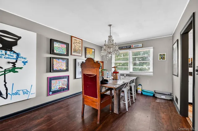 a view of a livingroom with furniture a flat screen tv and wooden floor