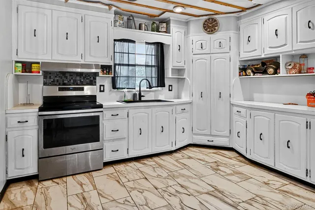 a kitchen with stainless steel appliances white cabinets and a refrigerator