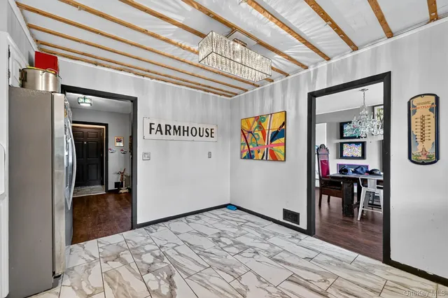 a view of a hallway with wooden floor and furniture