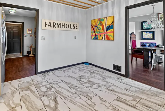 a view of a hallway with wooden floor and dining room