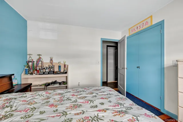 a bedroom with a bed and a dresser in it