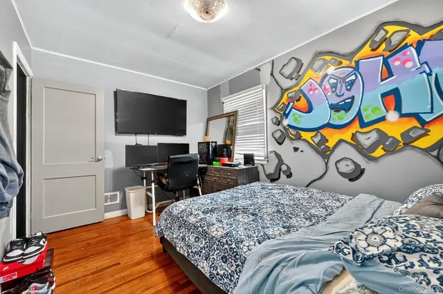 a bedroom with a bed and a flat screen tv