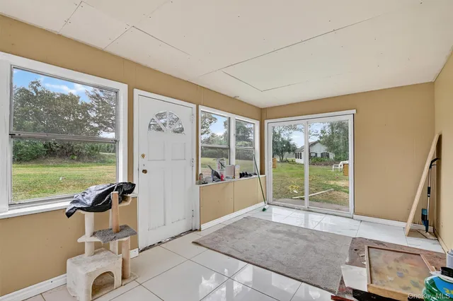 a living room with hardwood floor and balcony