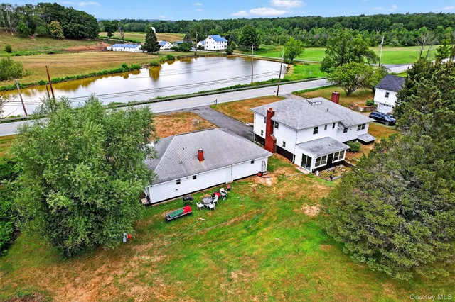 an aerial view of house with yard swimming pool and outdoor seating
