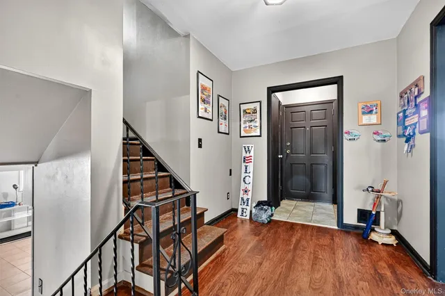 a view of an entryway with wooden floor and stairs