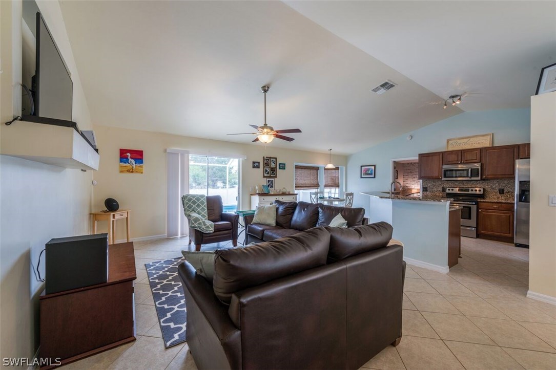 7274 Myrtle Road Fort Myers, FL 33967 - Photo 11 of 25 a living room with furniture a chandelier and kitchen view