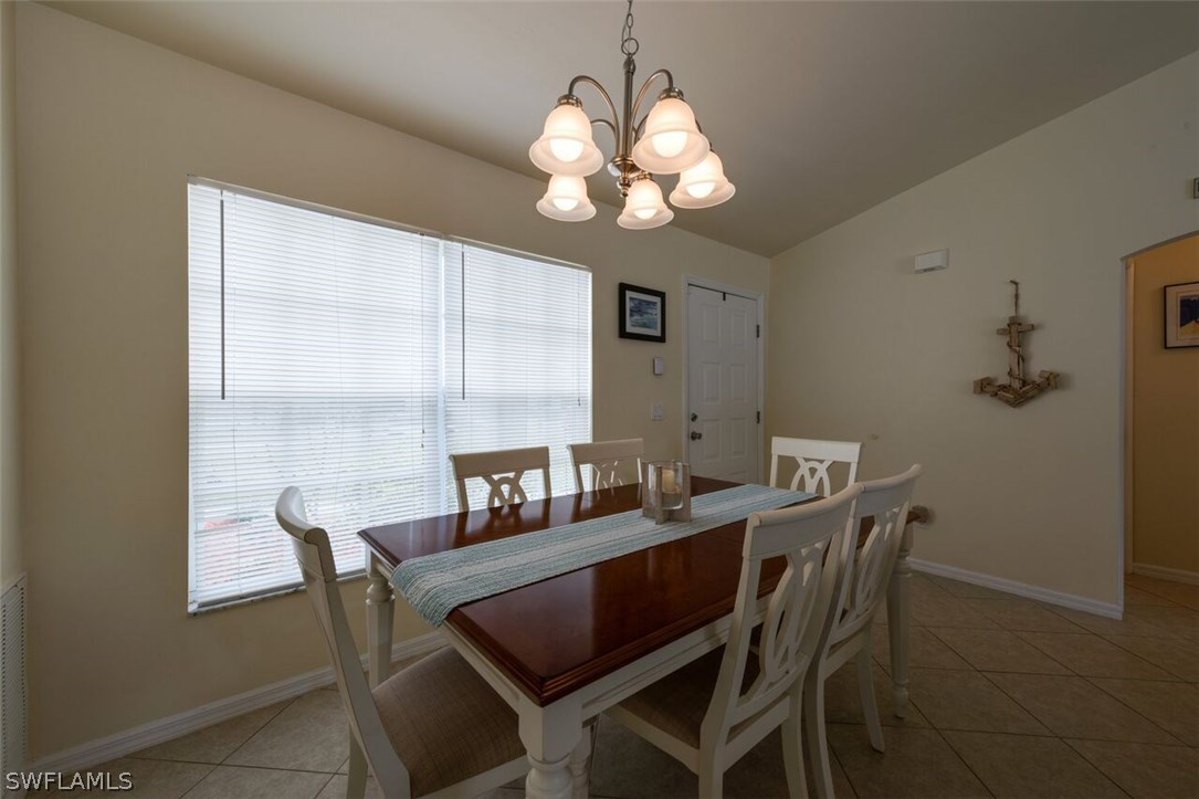 7274 Myrtle Road Fort Myers, FL 33967 - Photo 13 of 25 a view of a dining room with furniture and chandelier