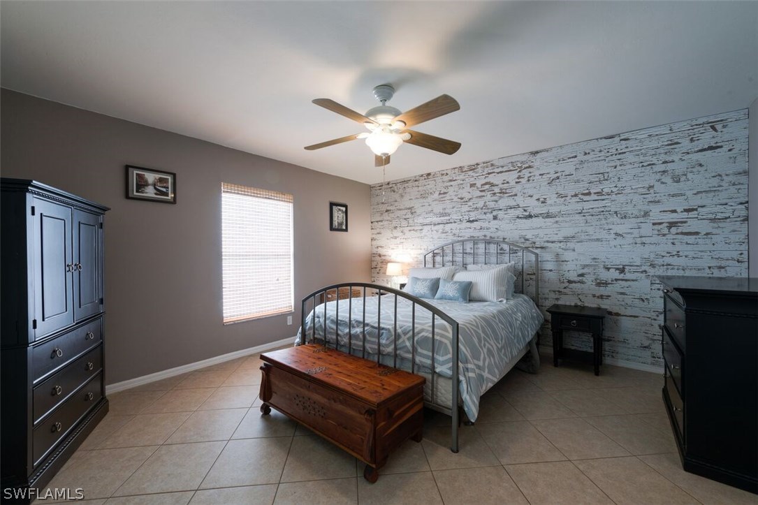 7274 Myrtle Road Fort Myers, FL 33967 - Photo 14 of 25 a bedroom with a bed and a chandelier