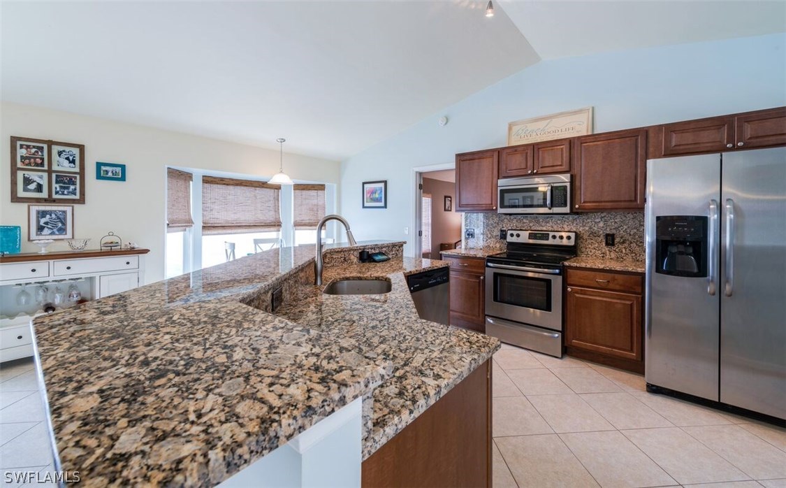 7274 Myrtle Road Fort Myers, FL 33967 - Photo 3 of 25 a kitchen with stainless steel appliances granite countertop a stove refrigerator and a sink