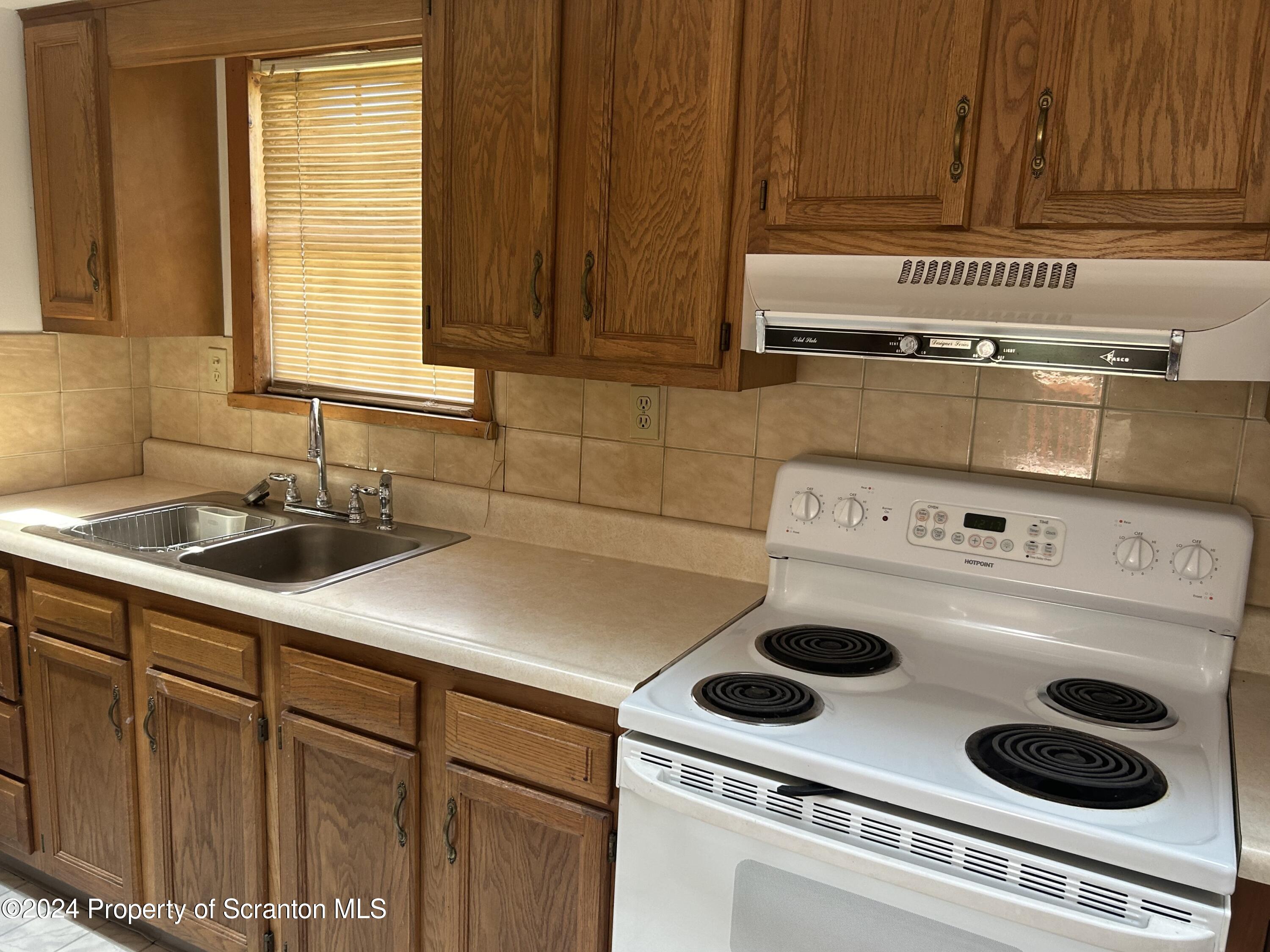 80 Worth Church Road Jermyn, PA 18433 - Photo 2 of 16 a kitchen with a stove and a sink