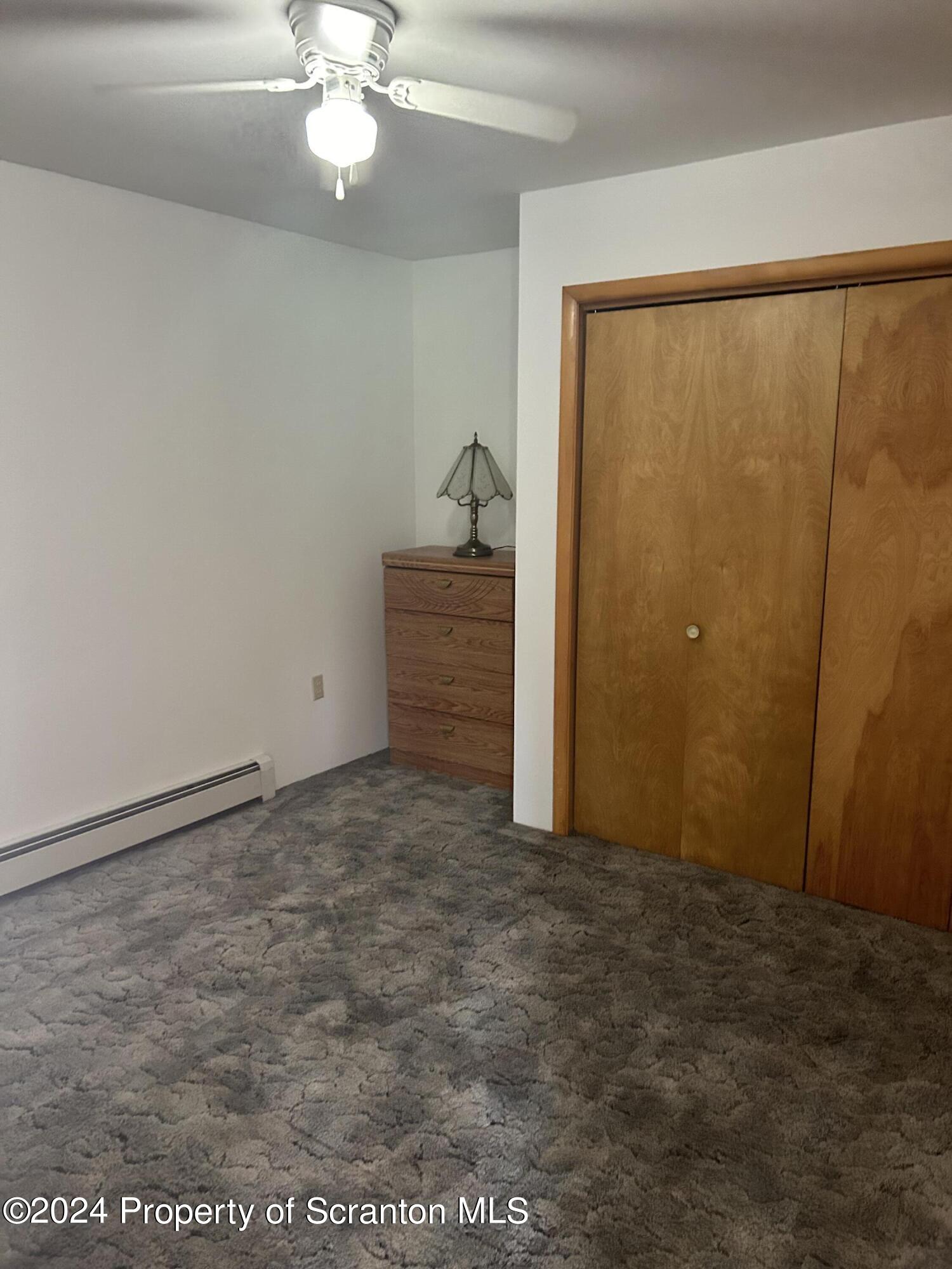80 Worth Church Road Jermyn, PA 18433 - Photo 7 of 16 a view of a room with a ceiling fan and window