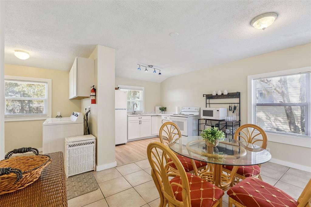 5108 South Ridgewood Avenue Port Orange, FL 32127 - Photo 11 of 44 a living room with furniture and a dining table with kitchen view