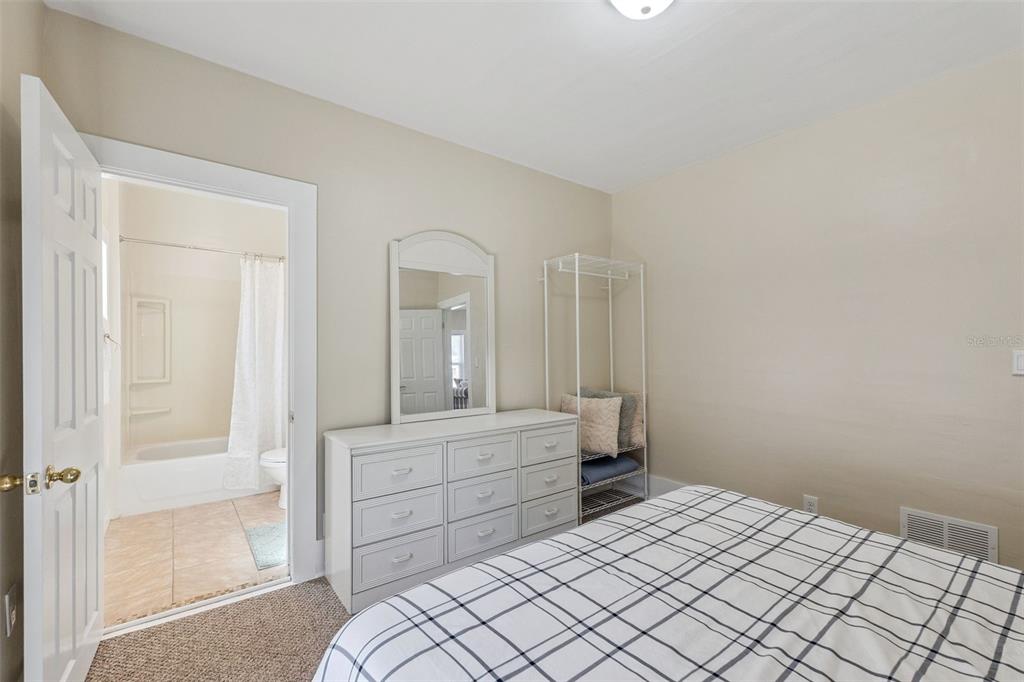 5108 South Ridgewood Avenue Port Orange, FL 32127 - Photo 15 of 44 a bedroom with a bed and a mirror