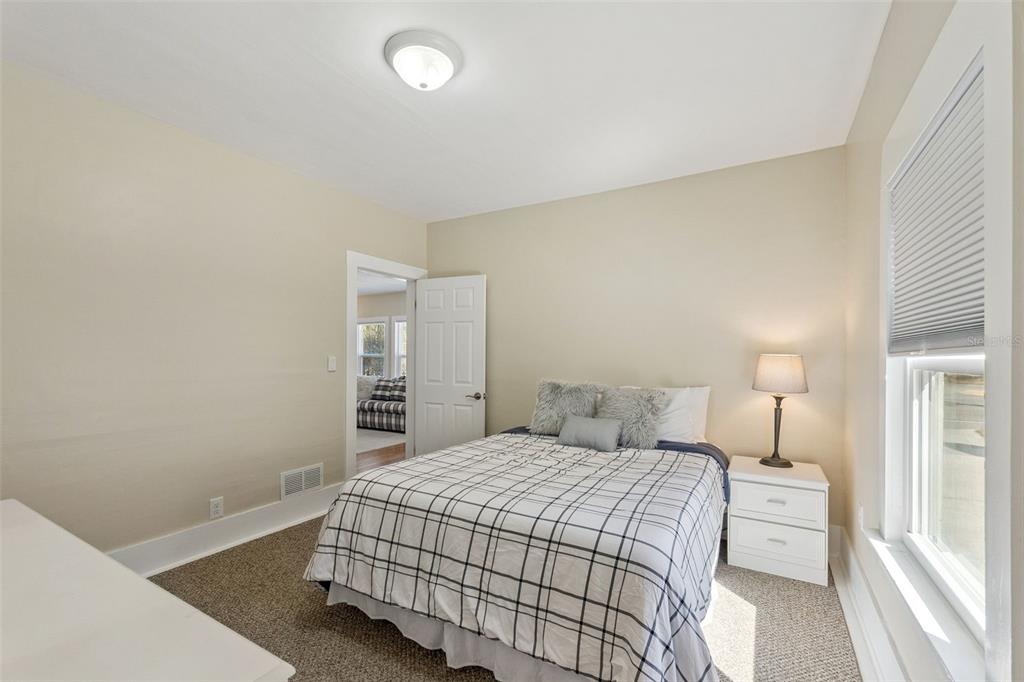 5108 South Ridgewood Avenue Port Orange, FL 32127 - Photo 16 of 44 a bedroom with a bed and a lamp