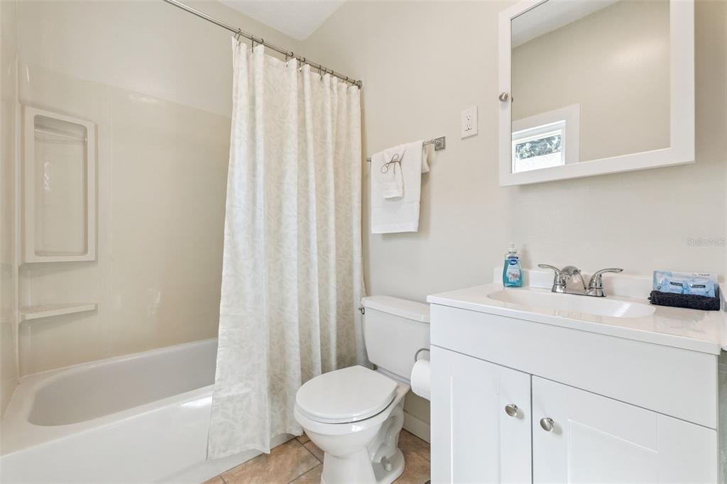 5108 South Ridgewood Avenue Port Orange, FL 32127 - Photo 19 of 44 a bathroom with a sink toilet and shower