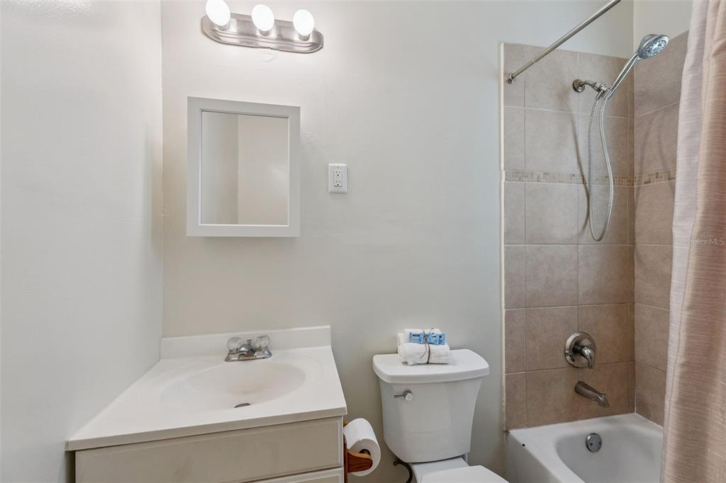 5108 South Ridgewood Avenue Port Orange, FL 32127 - Photo 20 of 44 a bathroom with a sink a toilet and shower