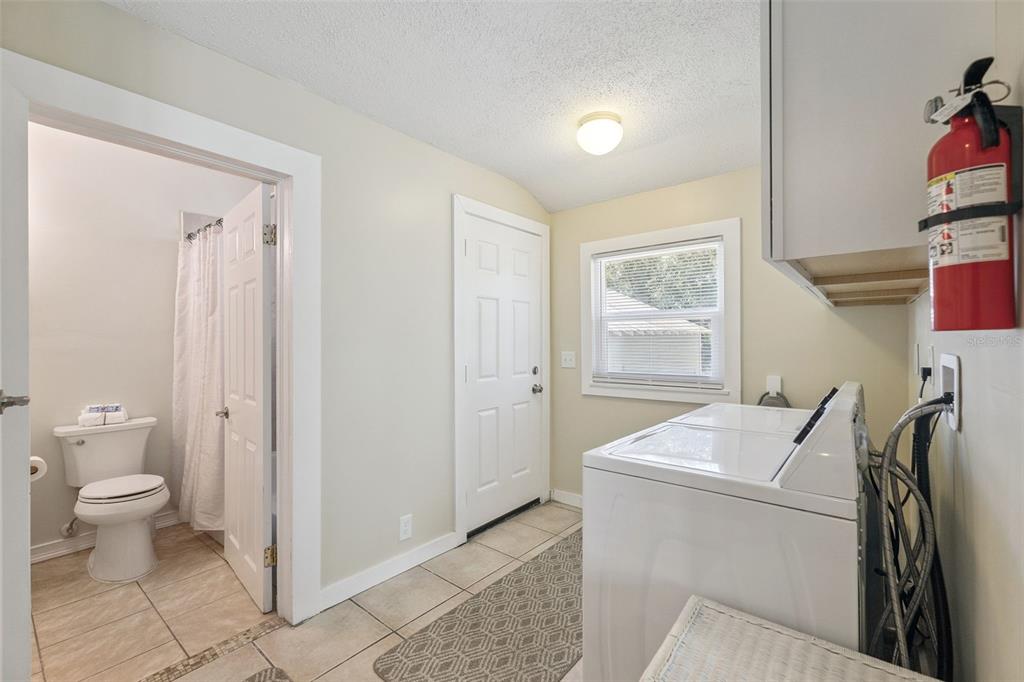 5108 South Ridgewood Avenue Port Orange, FL 32127 - Photo 21 of 44 a room with a washer and dryer