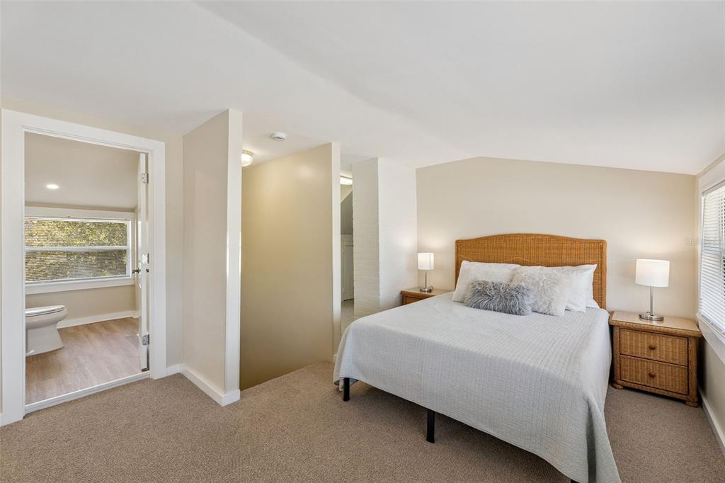 5108 South Ridgewood Avenue Port Orange, FL 32127 - Photo 24 of 44 a bedroom with a bed and a lamp