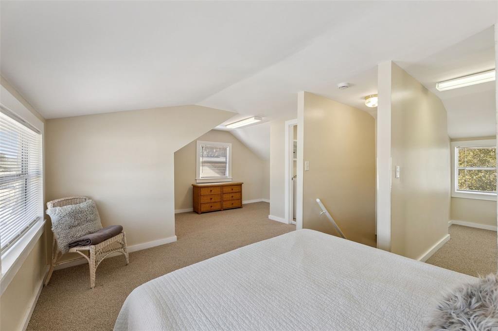 5108 South Ridgewood Avenue Port Orange, FL 32127 - Photo 25 of 44 a bedroom with a bed and a chair