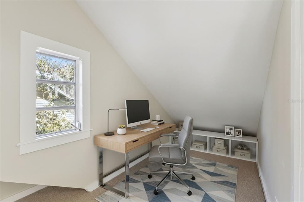 5108 South Ridgewood Avenue Port Orange, FL 32127 - Photo 30 of 44 a view of a workspace with furniture and a window