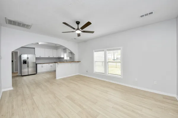 a kitchen with stainless steel appliances granite countertop a sink stove and white cabinets