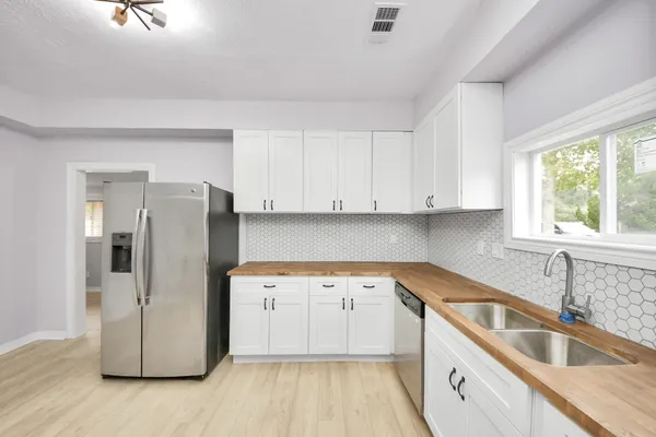 a view of a kitchen with a sink and dishwasher