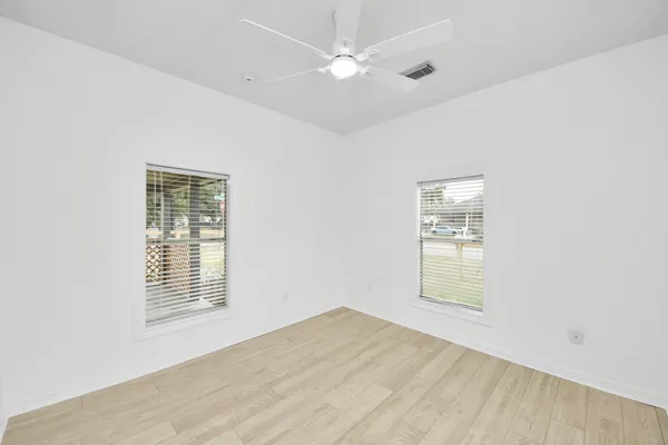a view of a room with wooden floor and white walls