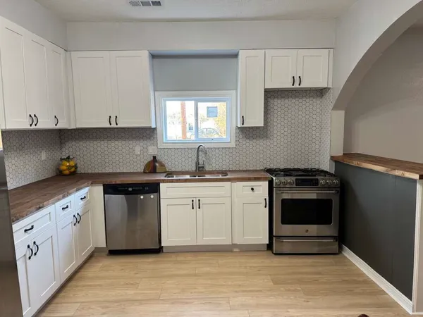 a living room with furniture and a ceiling fan