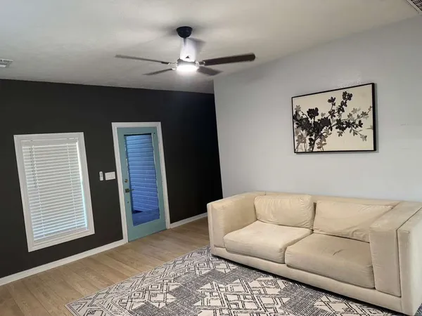 a living room with a dining table and wooden floor