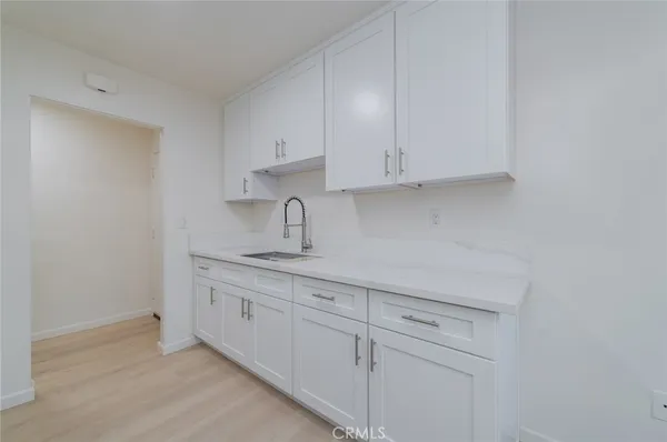 a kitchen with white cabinets