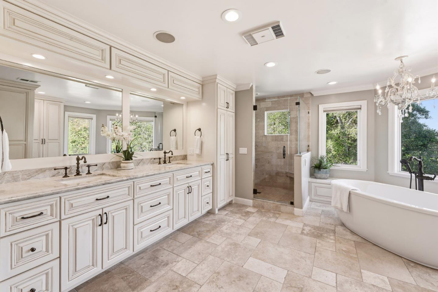 15965 Shannon Road Los Gatos, CA 95032 - Photo 19 of 53 a spacious bathroom with a granite countertop sink a mirror a bathtub and next to a window