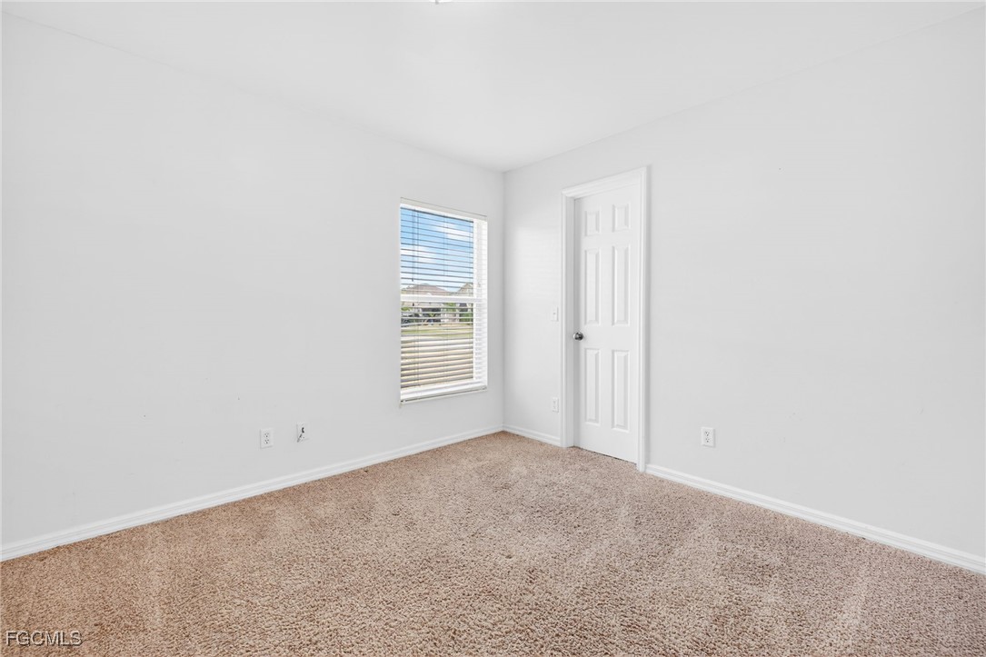 4664 Varsity Circle Lehigh Acres, FL 33971 - Photo 11 of 31 an empty room with windows