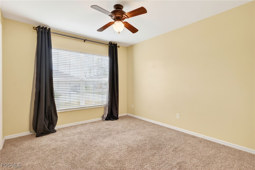 4664 Varsity Circle Lehigh Acres, FL 33971 - Photo 12 of 31 a view of room with a ceiling fan and window