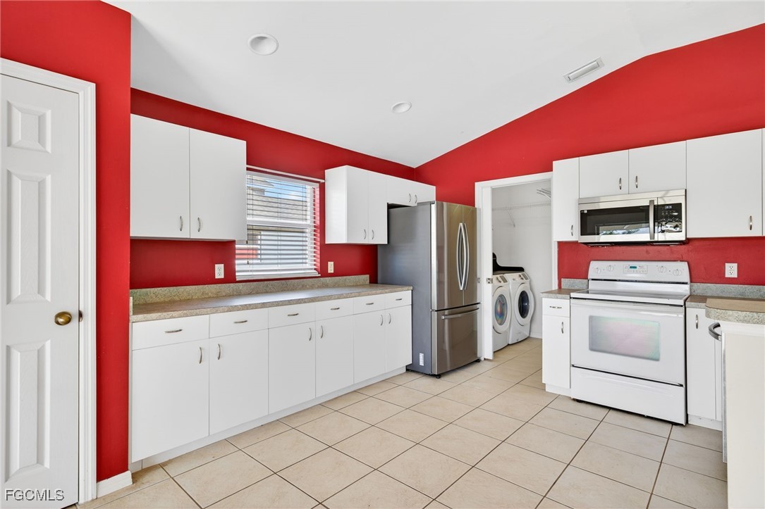 4664 Varsity Circle Lehigh Acres, FL 33971 - Photo 23 of 31 a kitchen with a refrigerator and sink