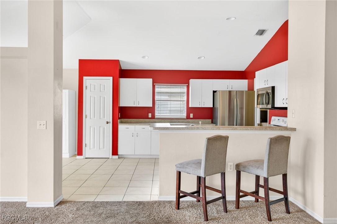 4664 Varsity Circle Lehigh Acres, FL 33971 - Photo 24 of 31 a room with a table and chairs in it