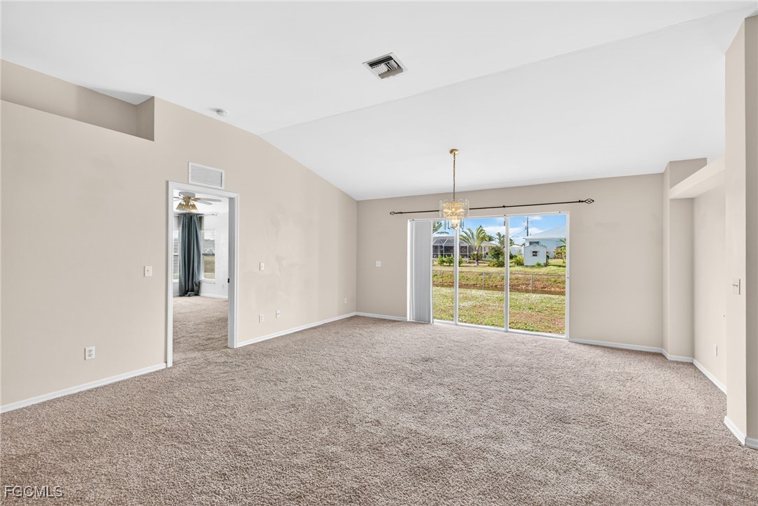 4664 Varsity Circle Lehigh Acres, FL 33971 - Photo 7 of 31 a view of an empty room with a fireplace and a large window