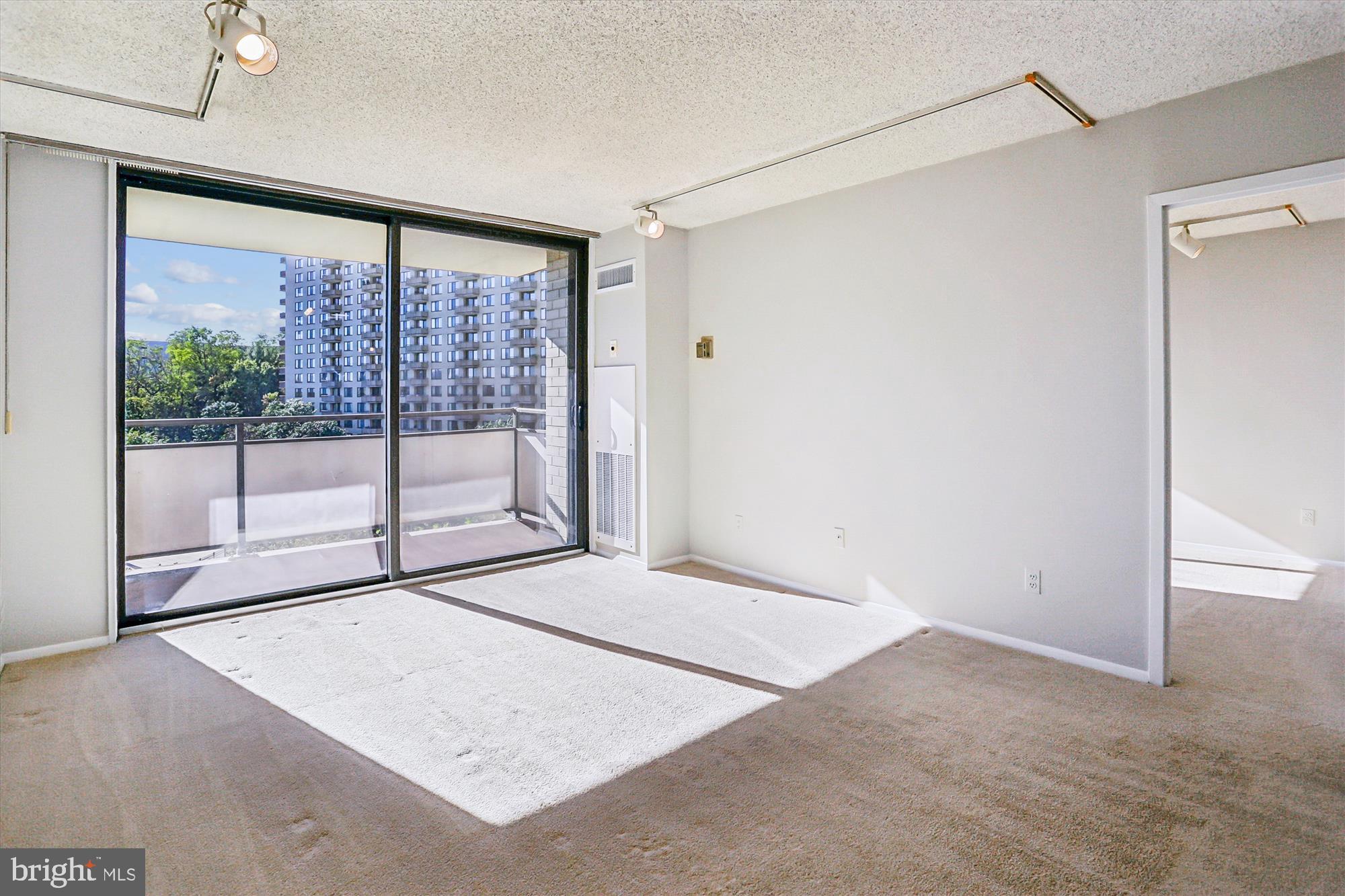 5225 Pooks Hill Road, Unit 417N Bethesda, MD 20814 - Photo 13 of 58 a view of an empty room with glass door