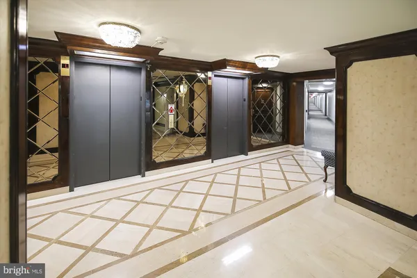 a view of a hallway with wooden floor and closet