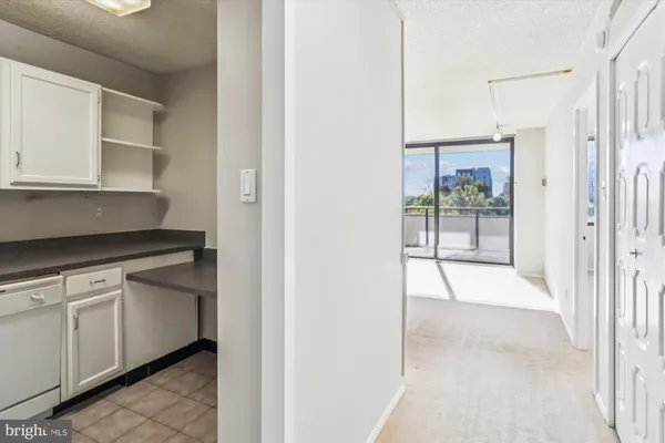 a kitchen with granite countertop white cabinets and white appliances