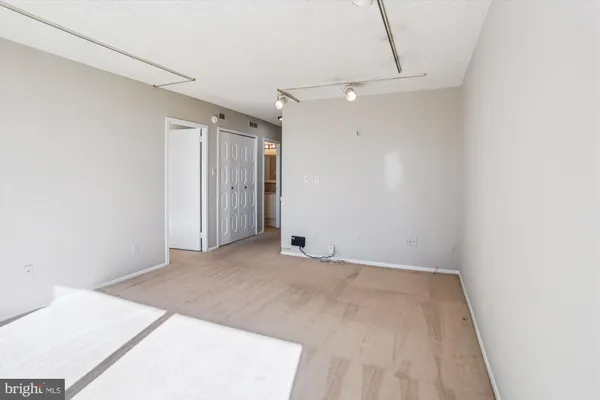 a view of an empty room with sliding glass door