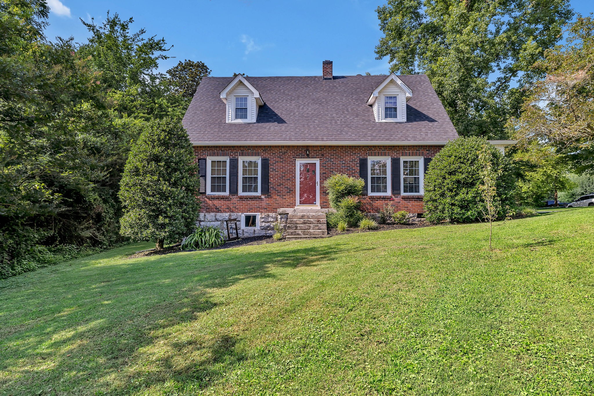 a front view of a house with a garden