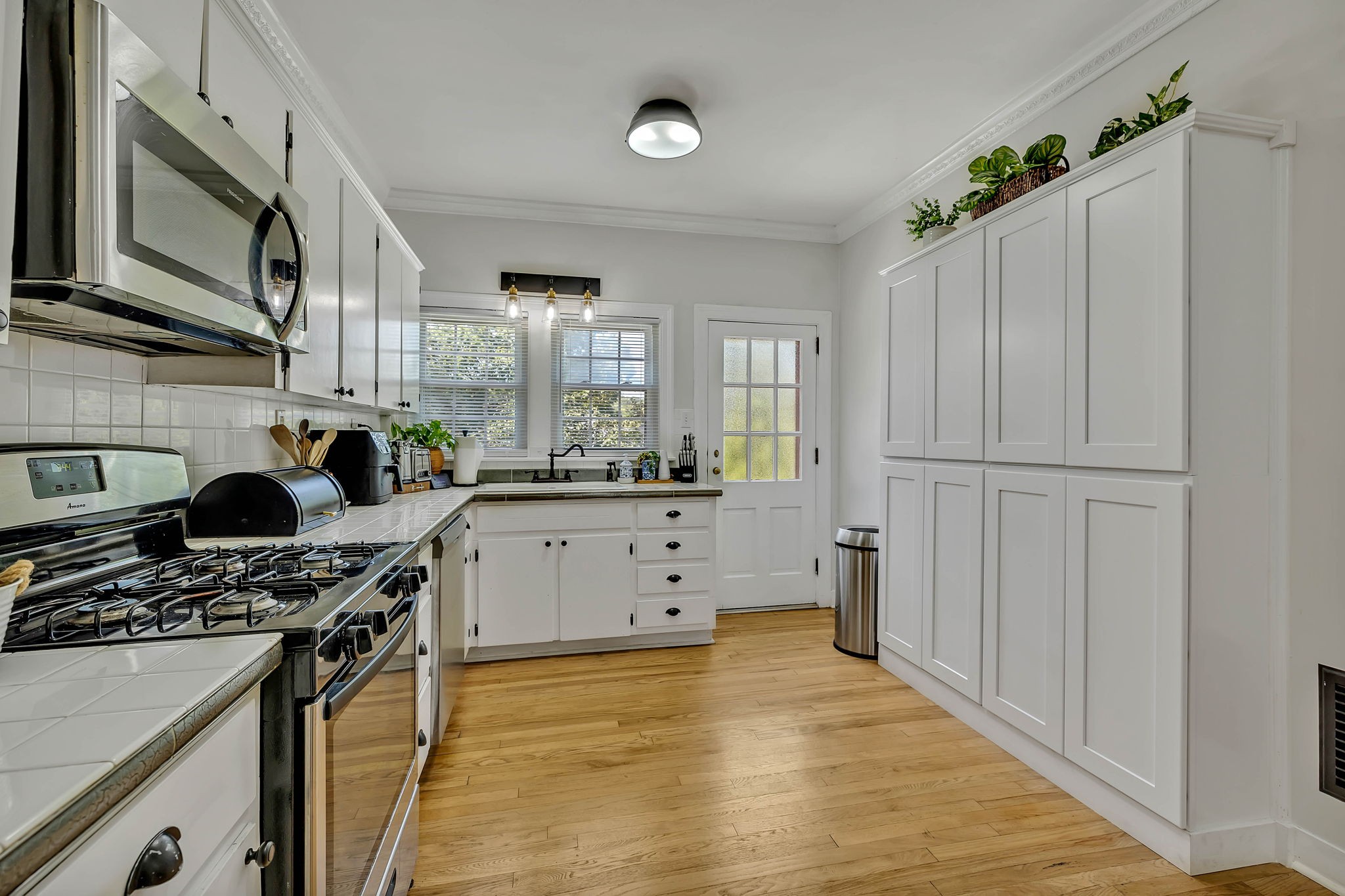 301 Cullum Street Carthage, TN 37030 - Photo 18 of 42 a kitchen with stainless steel appliances a stove a sink cabinets and a wooden floor