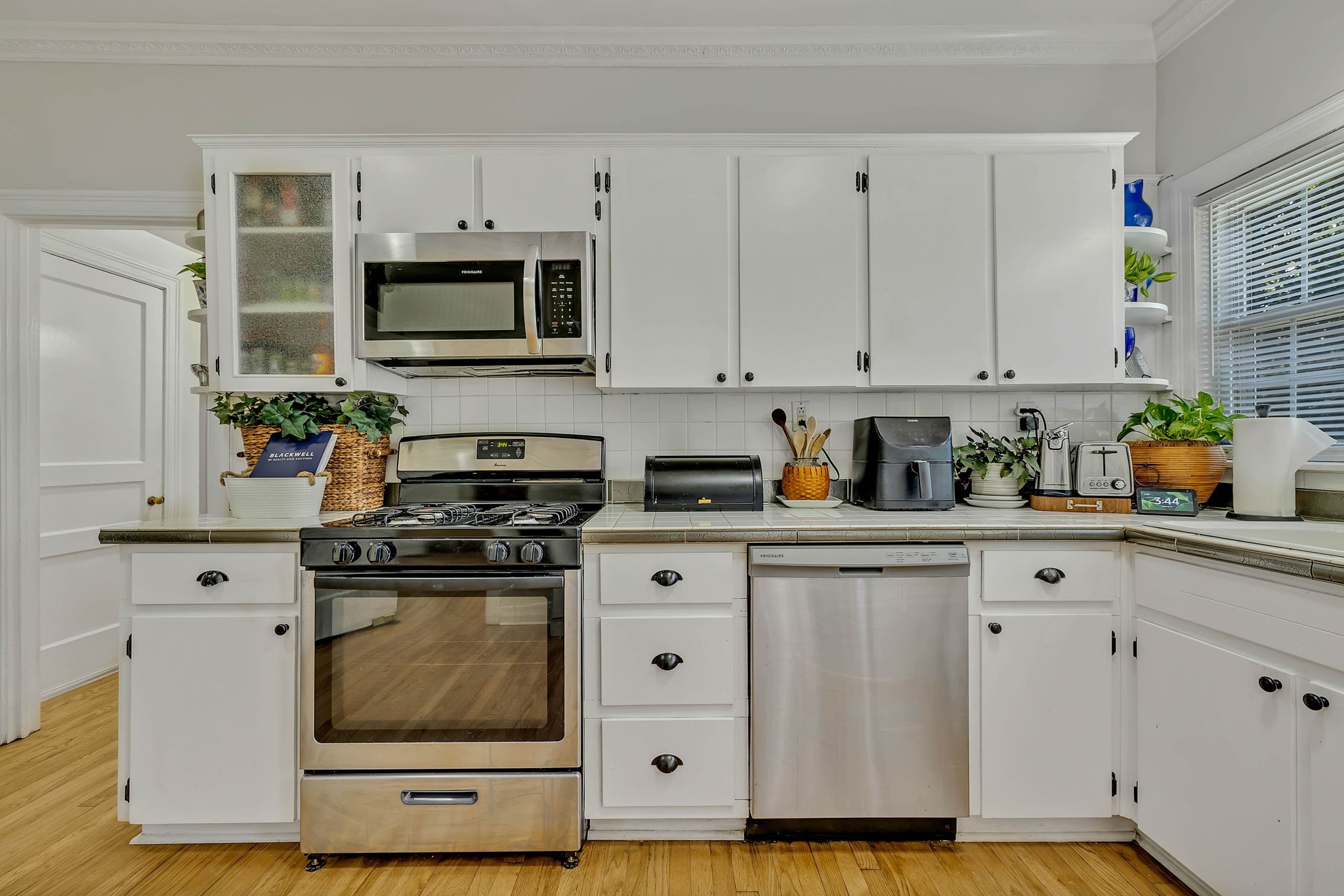 301 Cullum Street Carthage, TN 37030 - Photo 19 of 42 a white kitchen with stainless steel appliances granite countertop a stove a sink and white cabinets