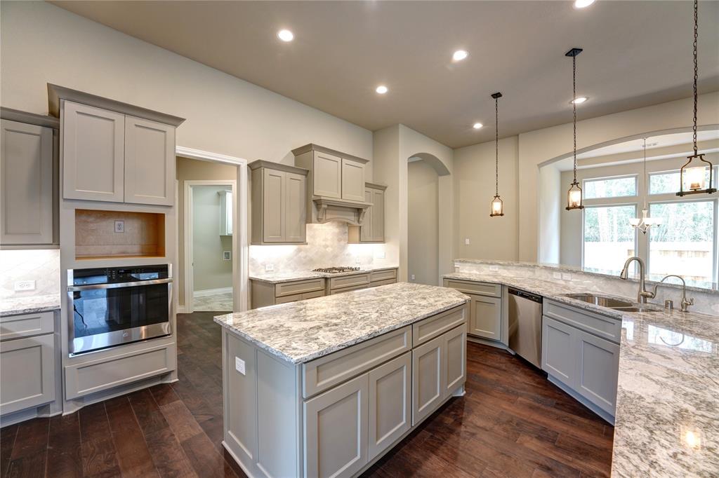 a kitchen with stainless steel appliances granite countertop wooden cabinets and sink