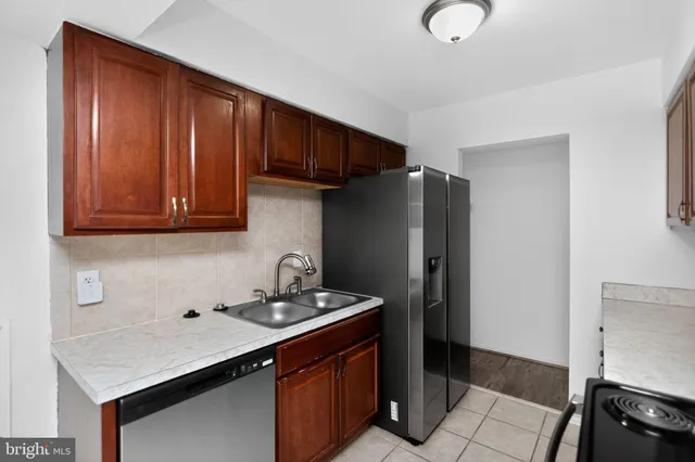 a kitchen with granite countertop cabinets stainless steel appliances and a sink