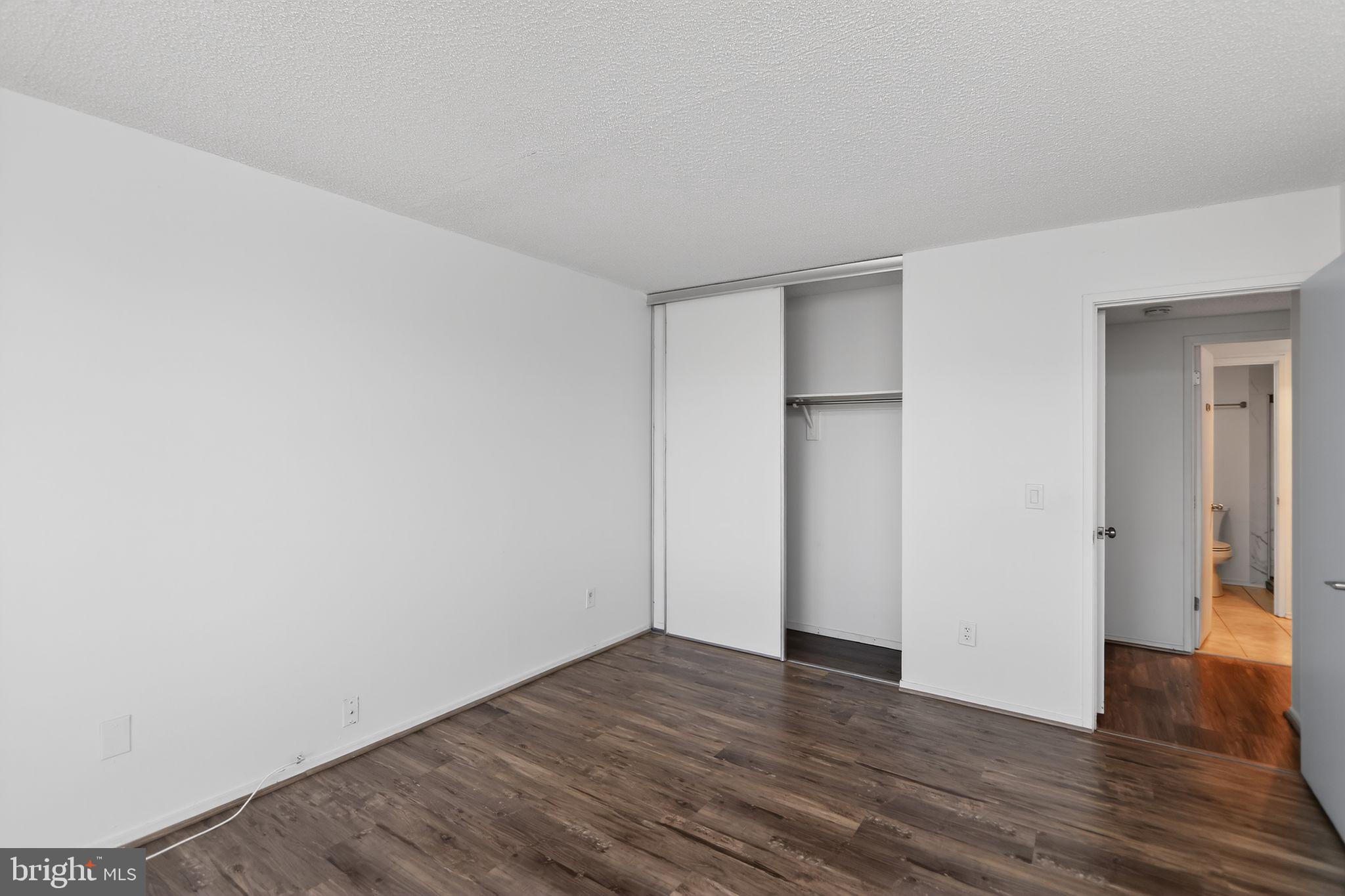 6101 Edsall Road, Unit 1704 Alexandria, VA 22304 - Photo 21 of 33 a view of an empty room with wooden floor and closet