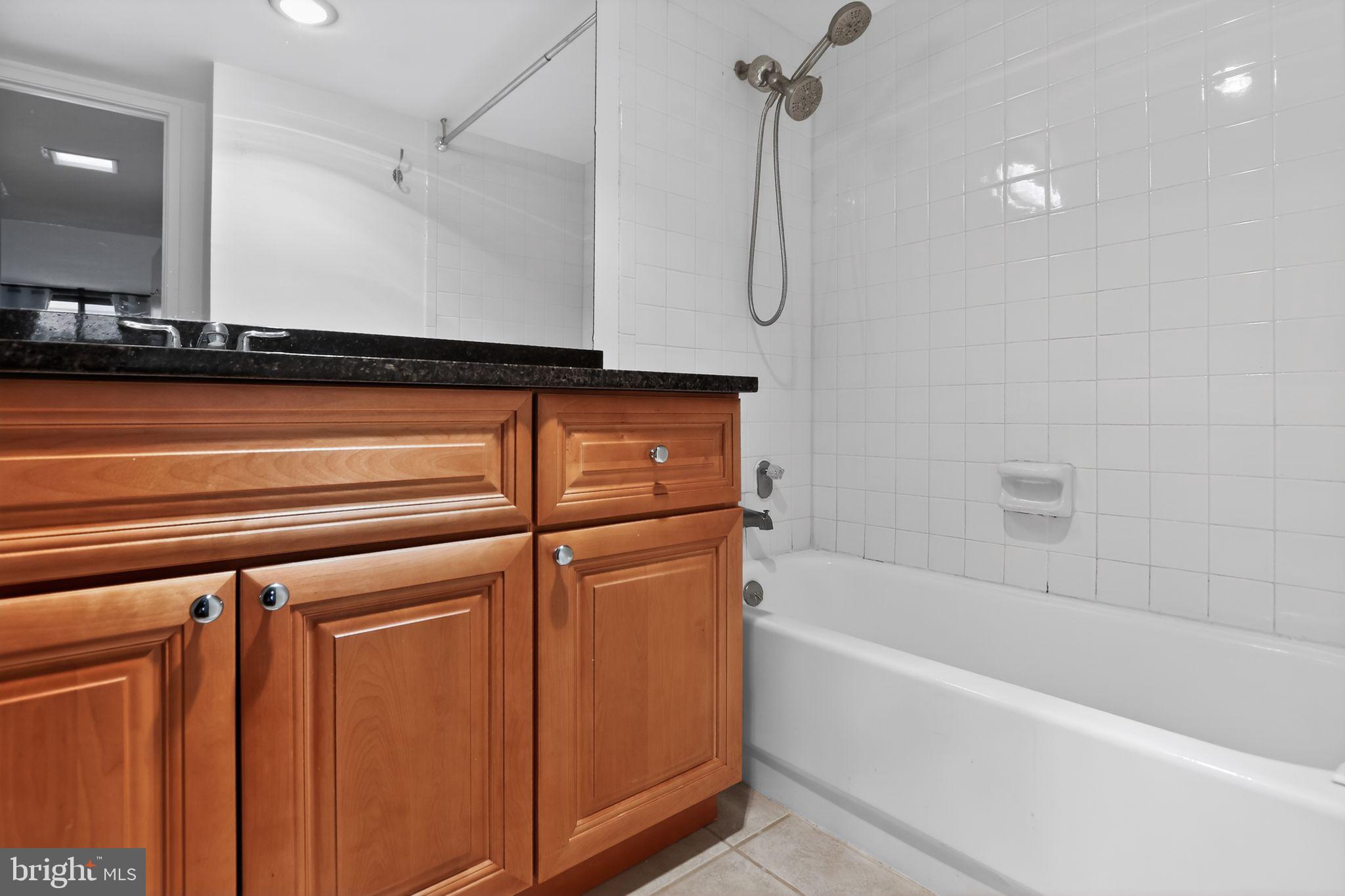 6101 Edsall Road, Unit 1704 Alexandria, VA 22304 - Photo 23 of 33 a bathroom with a bathtub and a shower