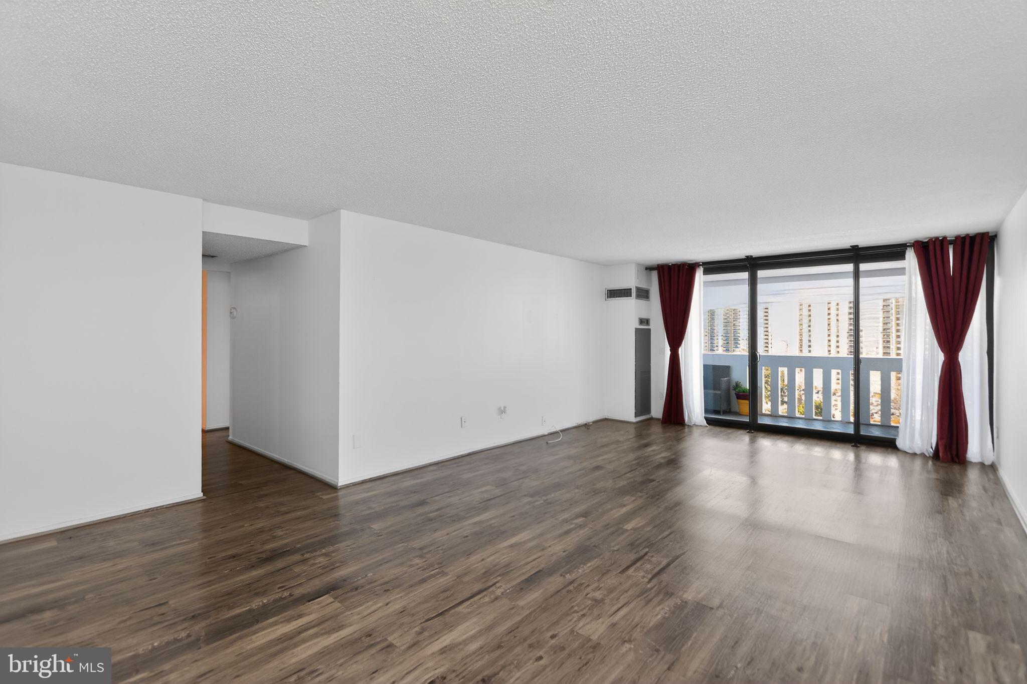 6101 Edsall Road, Unit 1704 Alexandria, VA 22304 - Photo 7 of 33 a view of an empty room with wooden floor and a window
