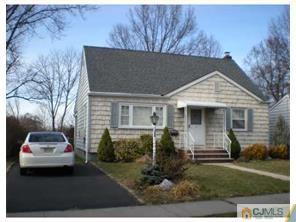 193 Midfield Road Colonia, NJ 07067 - Photo 1 of 2 a front view of a house with a garden