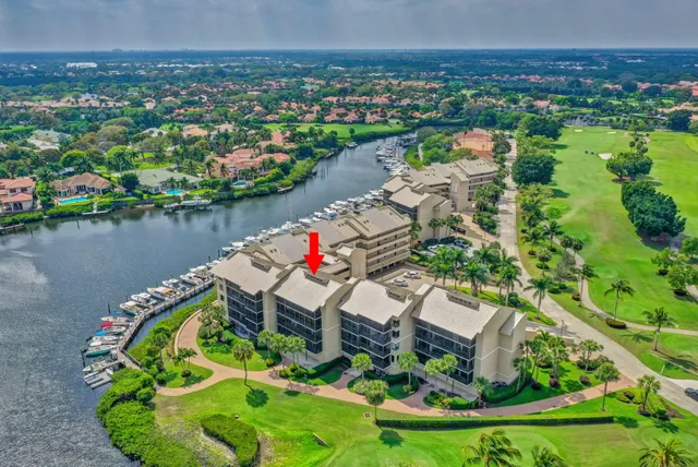 an aerial view of a house with a garden and lake view